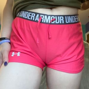 Pink, loose women’s under armor shorts.